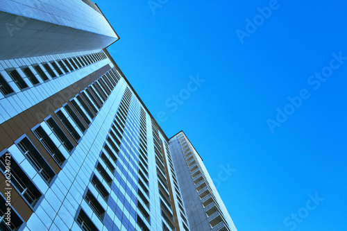 multistory building against the blue sky, bottom view