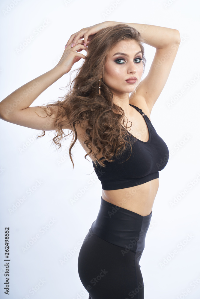 Fototapeta premium Beautiful girl in swimsuit posing against grey white background