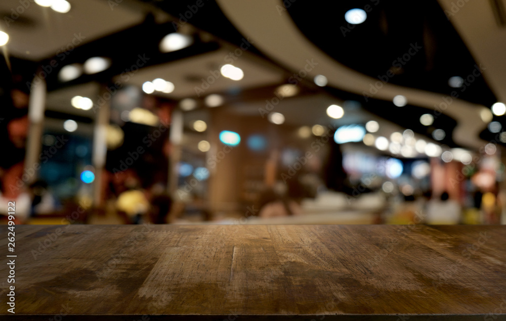 Empty dark wooden table in front of abstract blurred bokeh background of restaurant . can be used for display or montage your products.Mock up for space.