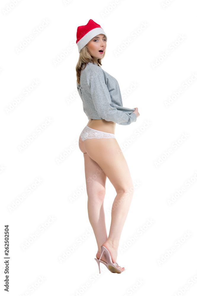 Beautiful sexual girl blonde pose in hat Santa Claus on white background is insulated Beautiful sexual girl blonde pose in hat Santa Claus on white background is insulated