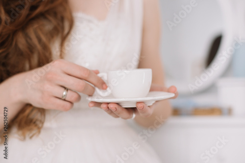 Girl with a  cup of coffee. Romantic breakfast. Morning of the bride. Concept of holiday, birthday, Easter, March 8 