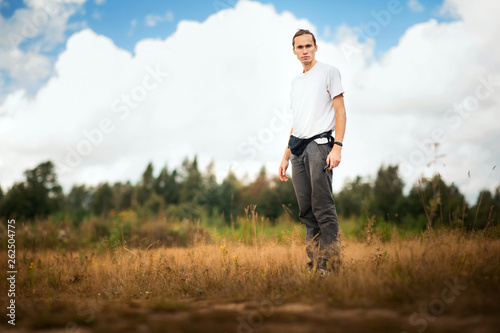 Portrait of a young caucasian man at nature