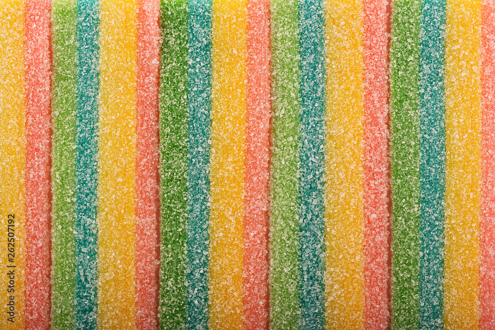 Top view on background texture and colorful licorice candy. Copy space for text.