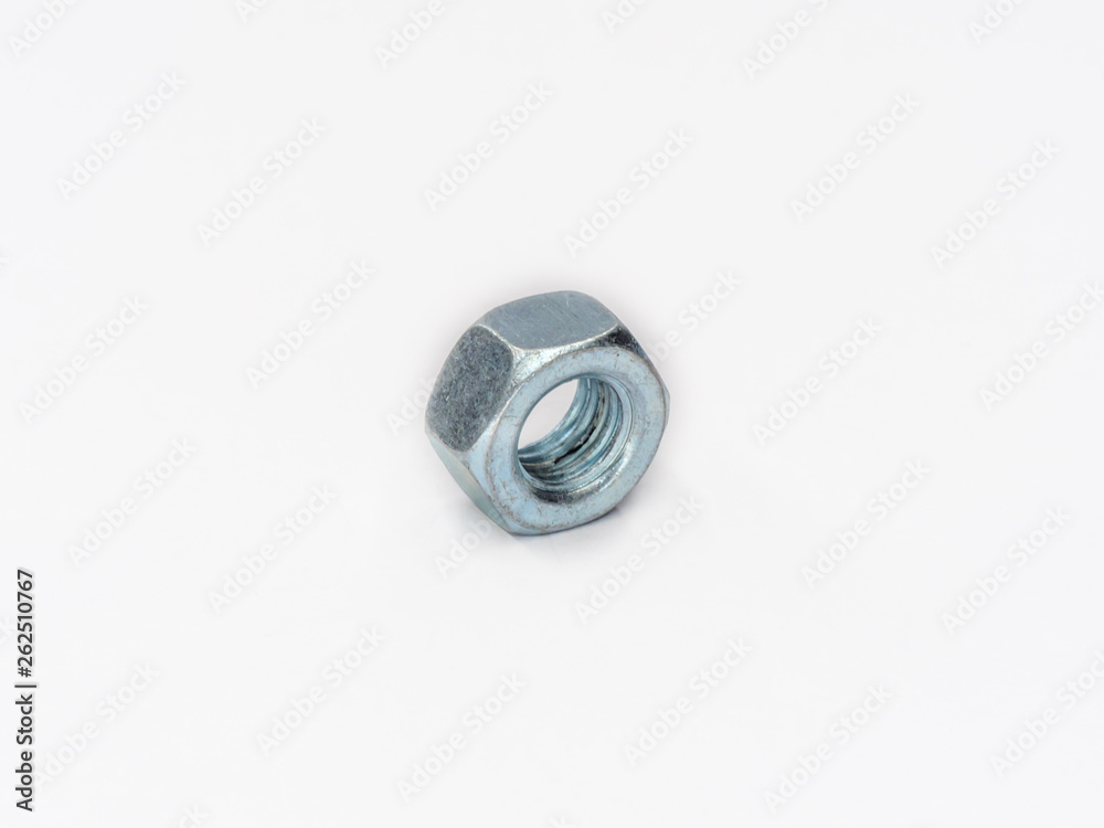Zinc plated hexagonal metric nut on white. Zinc plated hexagonal metric nut on white.