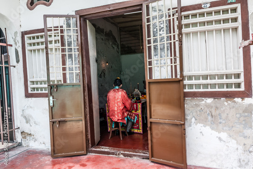 A Chinese praying at his home in George Town, Penang