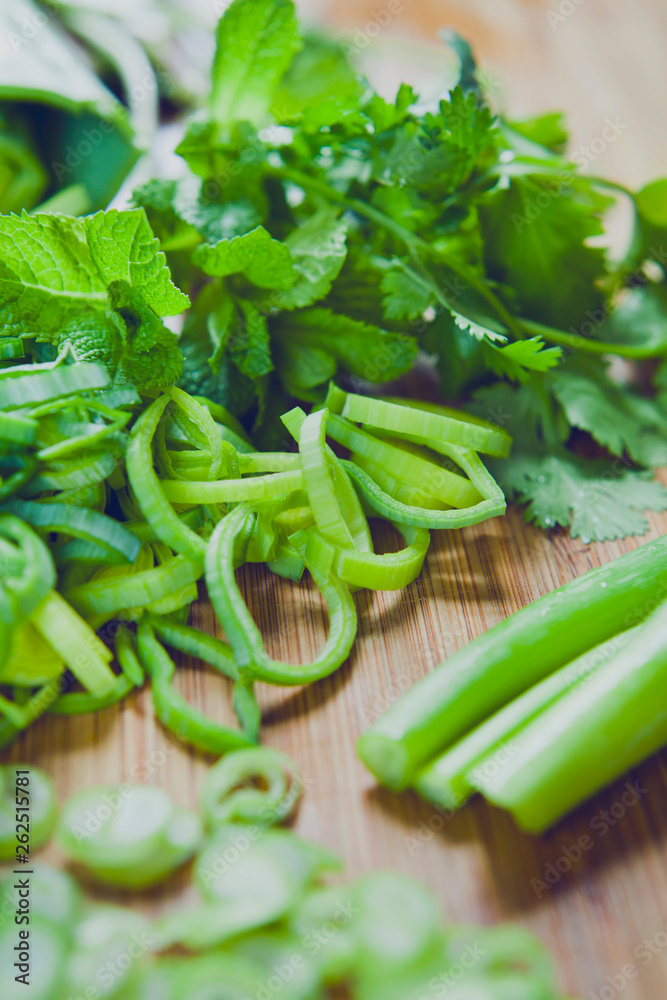 Fresh green leek vegetables and mint on the wooden board. Fresh green leek vegetables and mint on the wooden board.