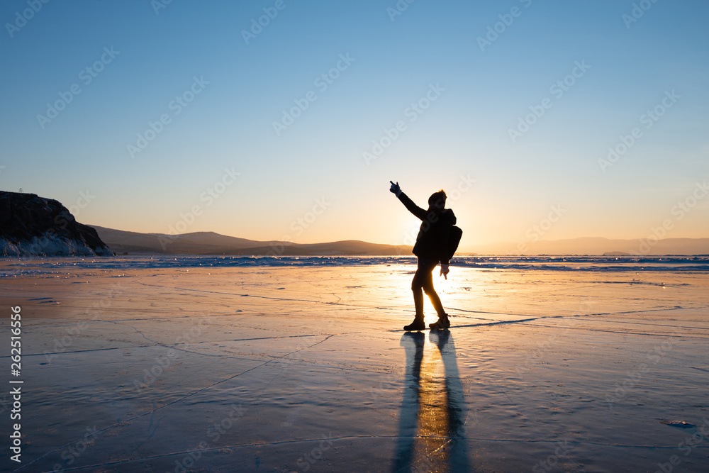 Silhouette photo of woman is walking and dancing on ice