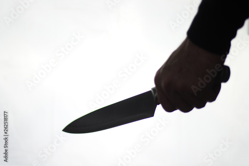 silhouette of a hand holding knife with white background