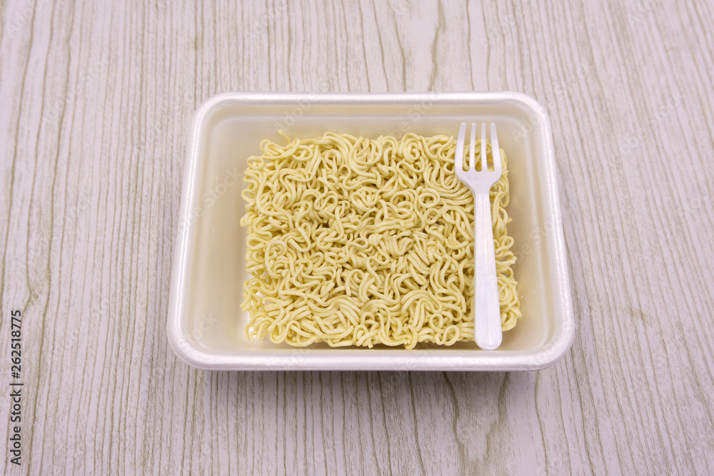 Instant noodles in a plate on a black background. Fast food, junk food, unhealthy food. Rolton Doshirak Instant noodles in a plate on a black background. Fast food, junk food, unhealthy food. Rolton Doshirak