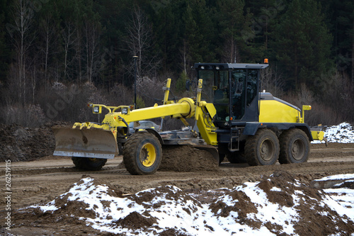 track-type bulldozer machine doing earthmoving work at sand quarry .