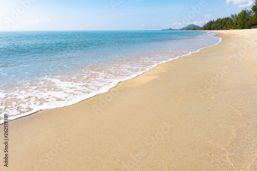 A peaceful beach scene in Thailand, exotic tropical beach landscapes and blue sea under the blue sky background, relaxing summer holiday design ideas.
