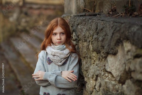 Fototapeta Naklejka Na Ścianę i Meble -  Portrait of a beautiful girl with red hair and freckles offended or angry