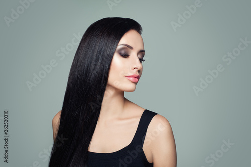 Beautiful woman with long healthy straight hair and makeup portrait
