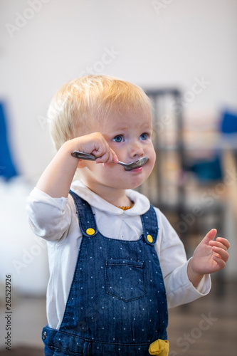 cute baby eating with spoon