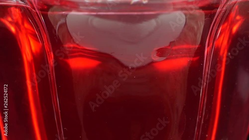 Tasty red jelly in bowl. red substance in a glass bowl photo