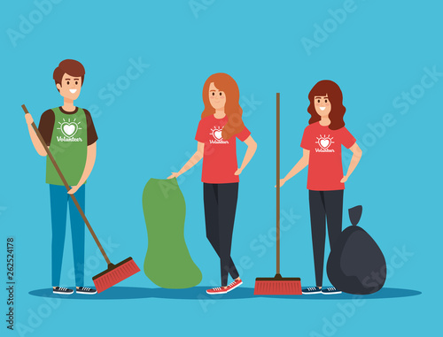boy and girls volunteers with brooms and trash bag