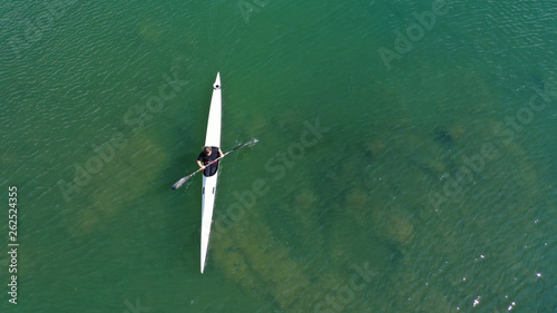 Aerial drone photo of women competing in sport canoe in calm water lake