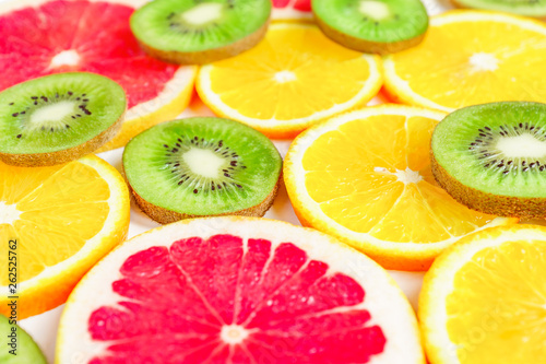 Fototapeta Naklejka Na Ścianę i Meble -  close up of citrus slice, kiwi, oranges and grapefruits isolated on white background. Fruits backdrop, selective focus