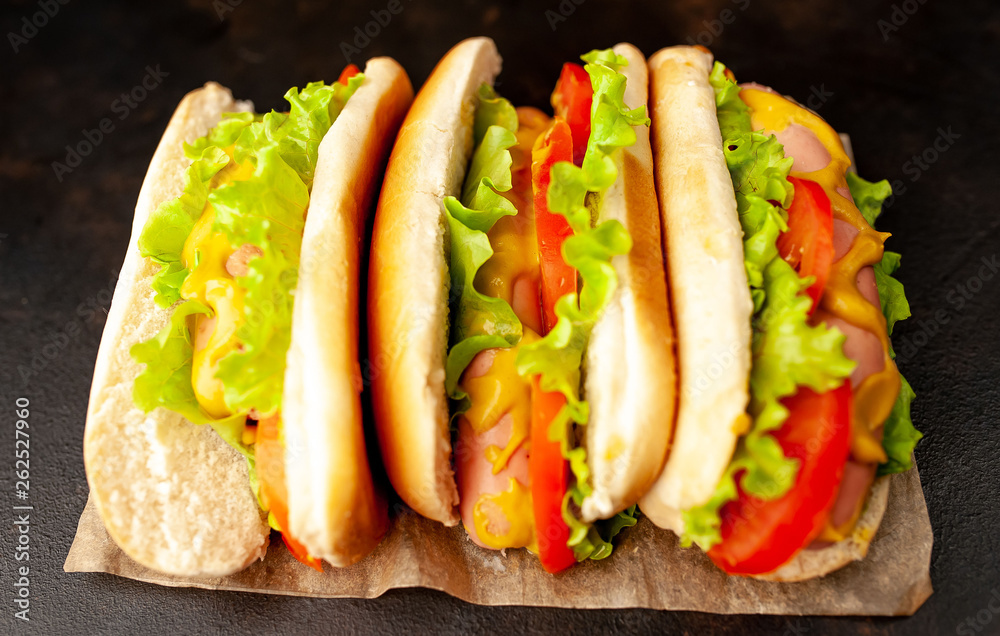 delicious hot dogs on a cutting board against a background of stone delicious hot dogs on a cutting board against a background of stone