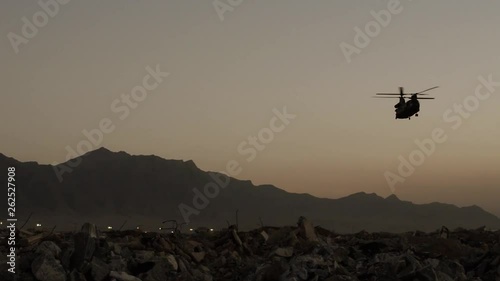 Chinook helicopter landing in an open field photo