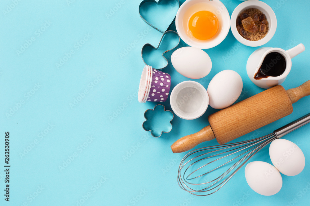 Ingredients and utensils for baking, blue background Ingredients and utensils for baking, blue background