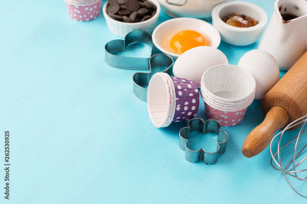 Obraz premium Ingredients and utensils for baking, blue background