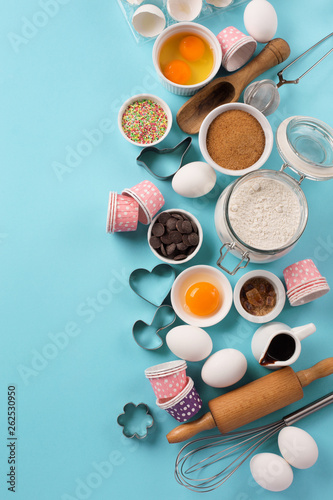 Ingredients and utensils for baking, blue background