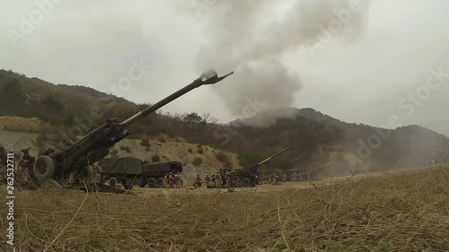 Soldiers firing M777 howitzers in an open field 2