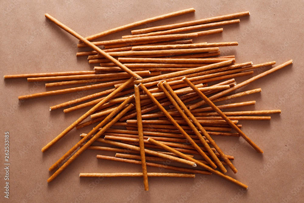 Crispy bread straw on brown paper background Crispy bread straw on brown paper background