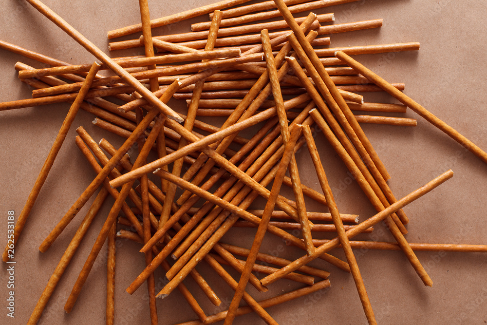 Crispy bread straw on brown paper background Crispy bread straw on brown paper background
