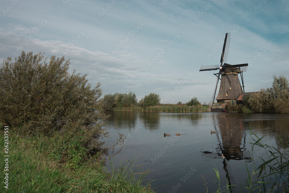 mill in Unesco place Kinderdijk, The Netherlands, along river Alblas