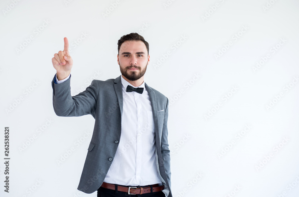 Handsome man with bearded in formal tuxedo and suit showing hand pointing on white background Handsome man with bearded in formal tuxedo and suit showing hand pointing on white background