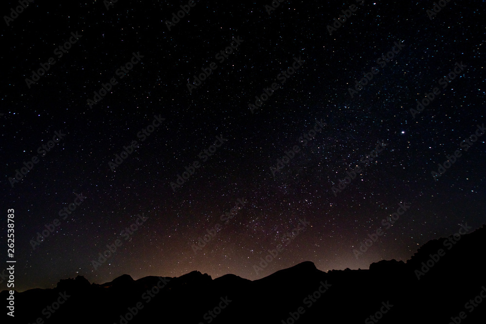 night photos on the Teide volcano in Tenerife. Images of the starry sky at night with the glow of the cities on the horizon night photos on the Teide volcano in Tenerife. Images of the starry sky at night with the glow of the cities on the horizon