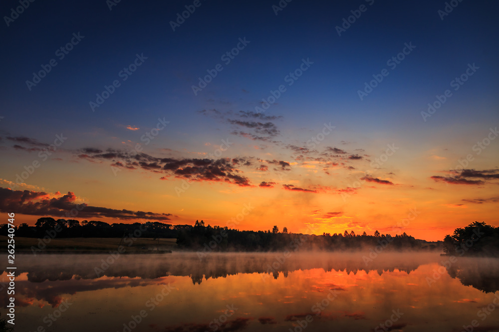 wonderful misty morning. majestic sunrise over the lake. picture