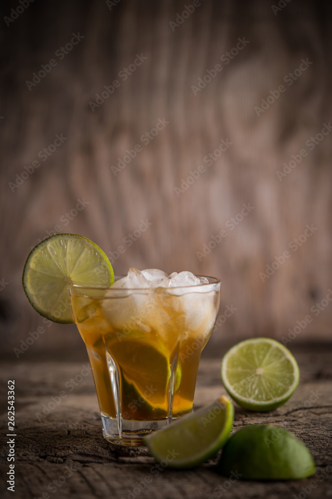 Caipirinha coctail with lemon slices and mint on rustic background Caipirinha coctail with lemon slices and mint on rustic background