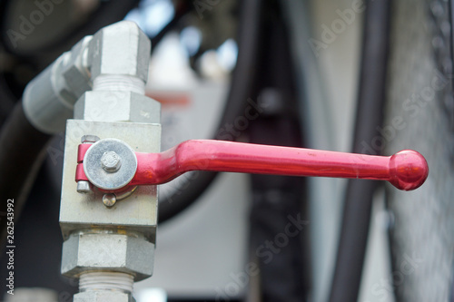 Red emergency handle on industrial equipment