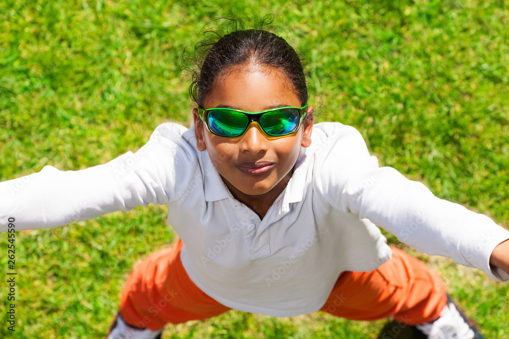 African boy in sunglasses standing on green lawn African boy in sunglasses standing on green lawn