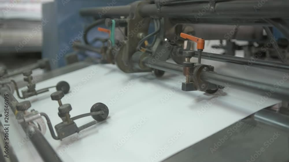 Video clip from the printing factory. Machine for feeding paper in operation. Details of modern equipment. Video clip from the printing factory. Machine for feeding paper in operation. Details of modern equipment.