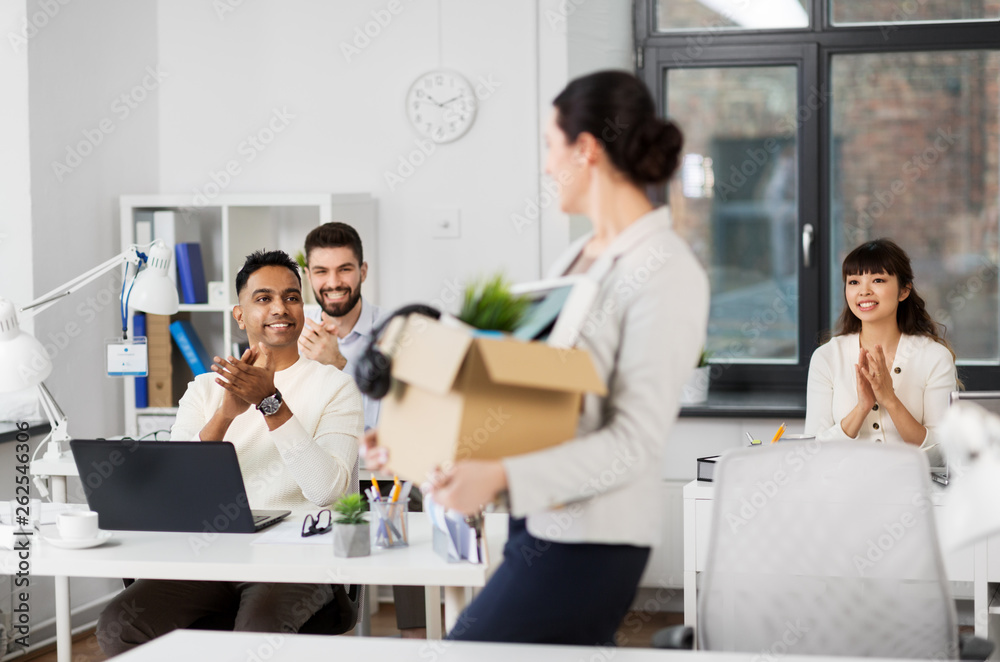 business, job and quit concept - happy smiling colleagues applauding to female office worker business, job and quit concept - happy smiling colleagues applauding to female office worker