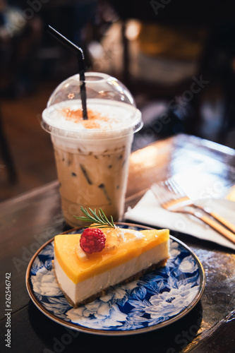 Iced cappuccino coffee and cheesecake on the table