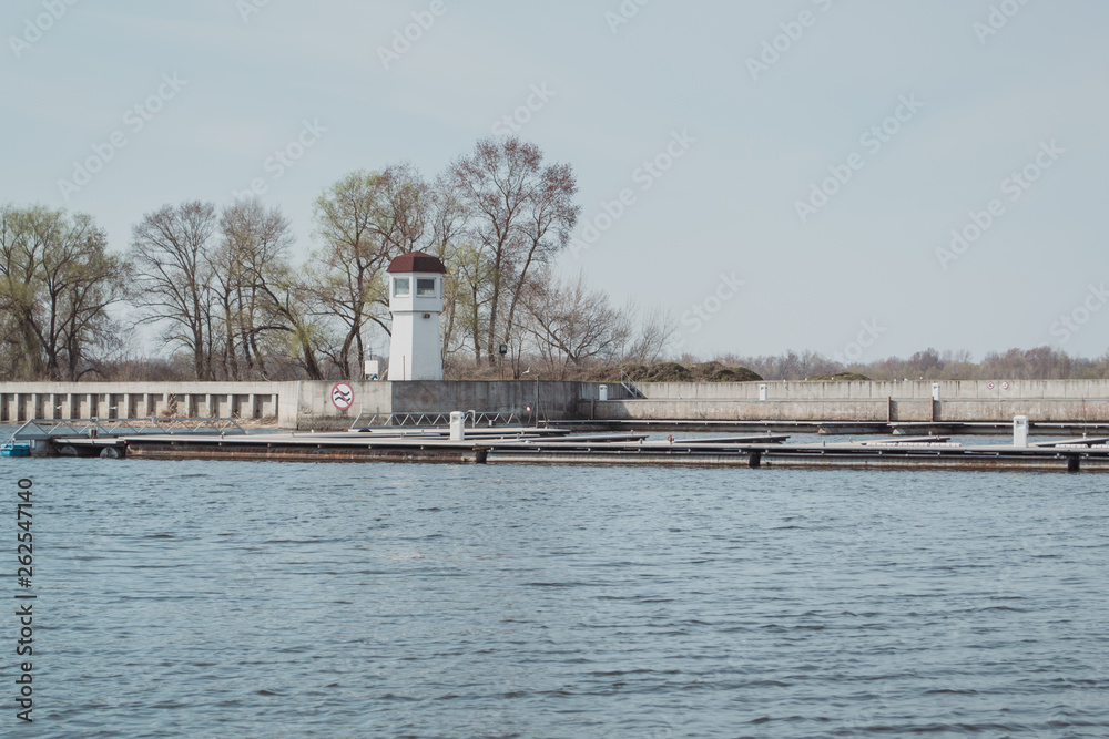 A small lighthouse on the bank of the river. A small lighthouse on the bank of the river.