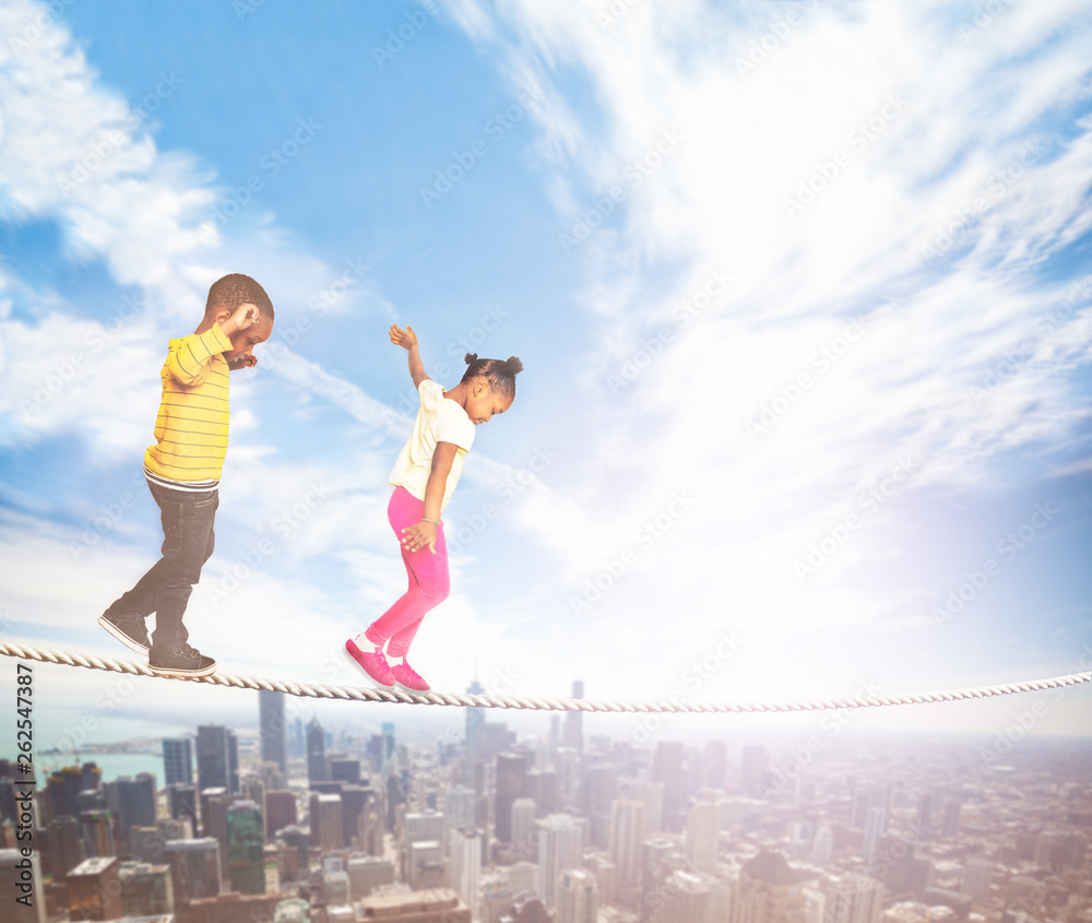 Two kids walking over the rope in modern city Two kids walking over the rope in modern city