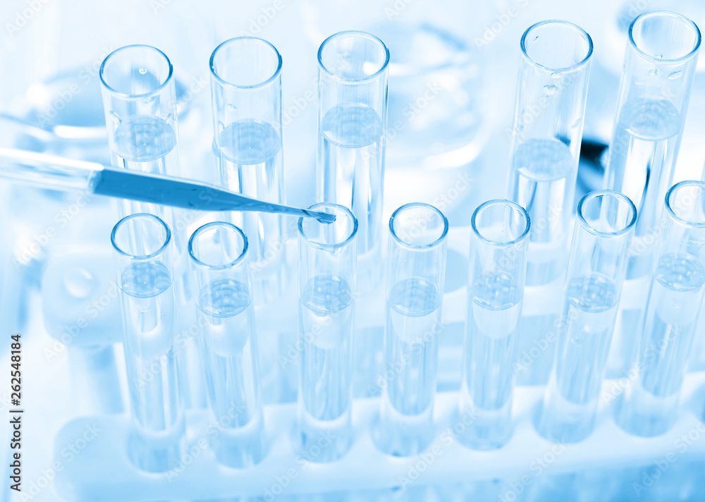 Laboratory beaker in analyst's hand in plastic glove Laboratory beaker in analyst's hand in plastic glove