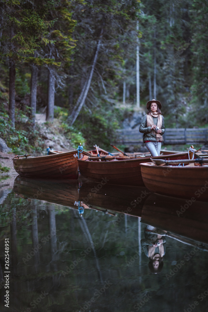 Young photographer with a retro camera in a boat