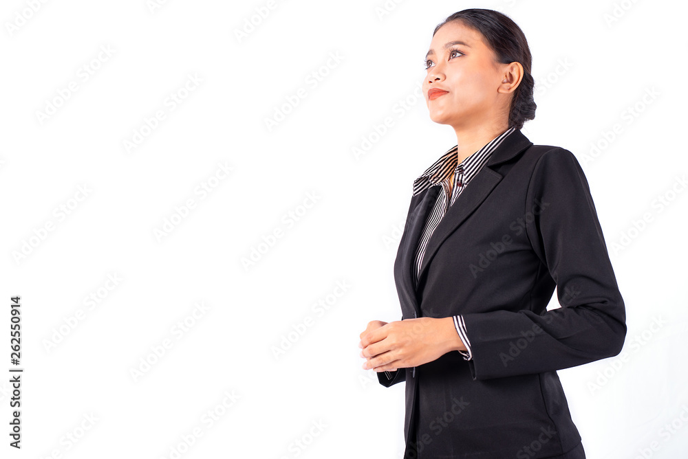 Portrait isolated Southeast Asian business woman wears dark gray suit is looking at left side and hold her hands on white background Portrait isolated Southeast Asian business woman wears dark gray suit is looking at left side and hold her hands on white background