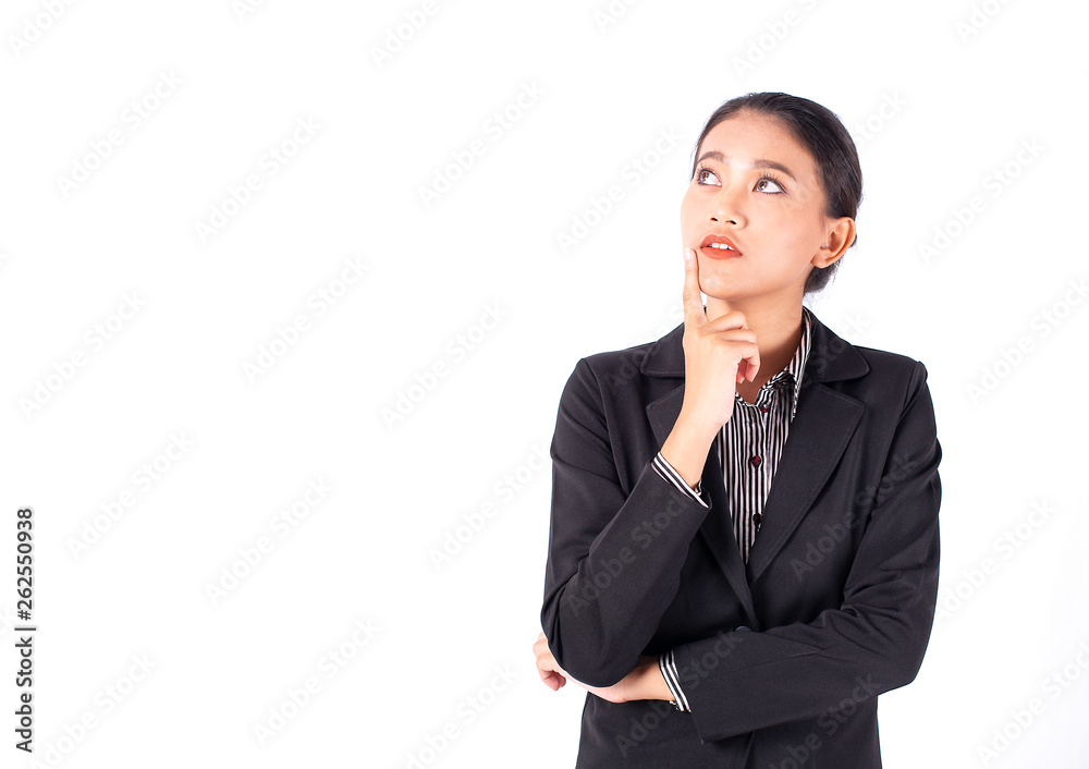 Portrait isolated Southeast Asian business woman wears dark gray suit is looking at left top side and place her hand on chin with white background Portrait isolated Southeast Asian business woman wears dark gray suit is looking at left top side and place her hand on chin with white background