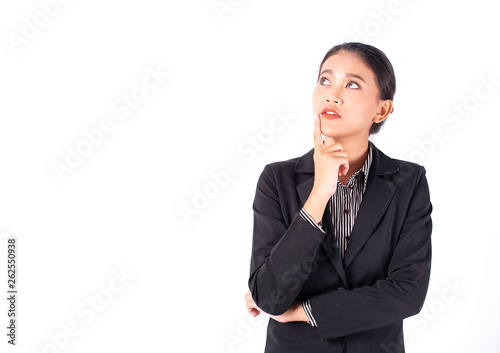 Portrait isolated Southeast Asian business woman wears dark gray suit is looking at left top side and place her hand on chin with white background