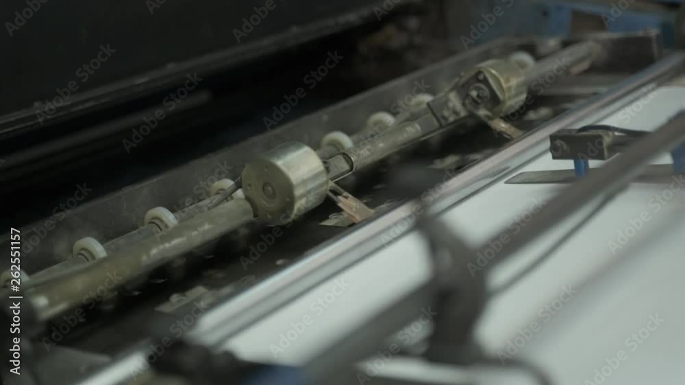 Video clip from the printing factory. Machine for feeding paper in operation. Details of modern equipment. Video clip from the printing factory. Machine for feeding paper in operation. Details of modern equipment.