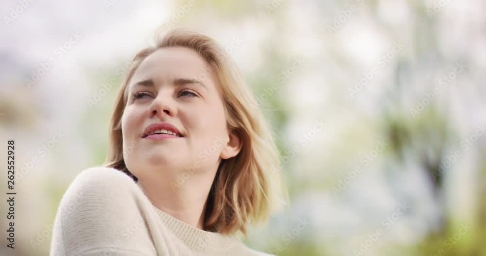 Beautiful female looking at the blooming nature around her Beautiful female looking at the blooming nature around her