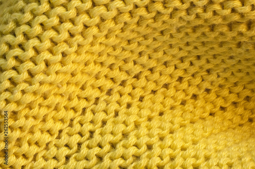 Artistic background from yellow knitted